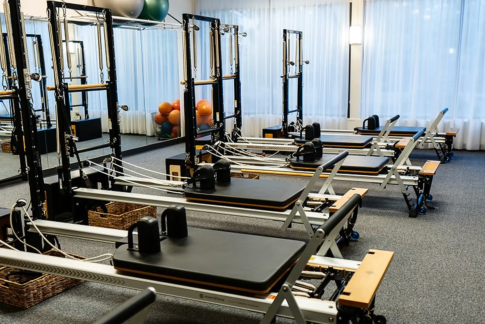 Rows of reformers in the studio at Pacific Northwest Pilates